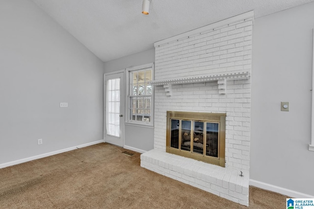 unfurnished living room with carpet floors, visible vents, a brick fireplace, vaulted ceiling, and baseboards