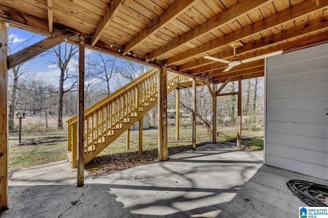 view of patio / terrace featuring ceiling fan and stairway