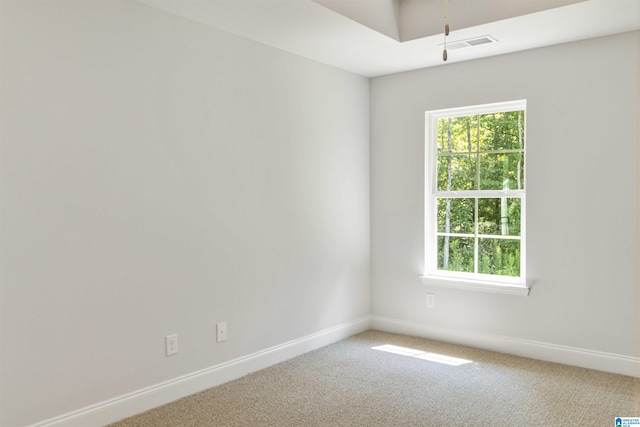 carpeted empty room with visible vents and baseboards