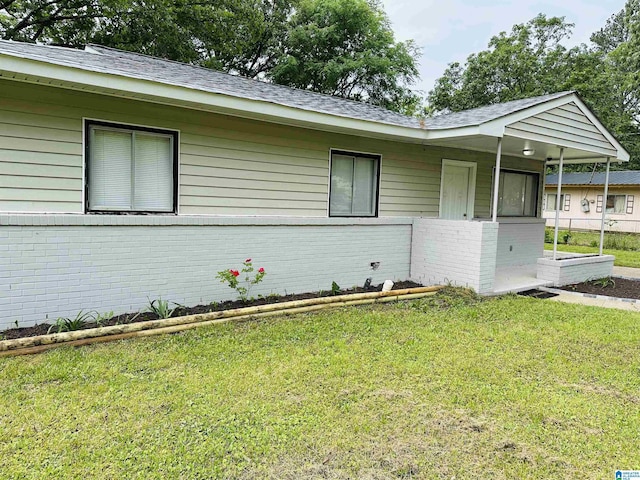 view of front of home with brick siding and a front yard