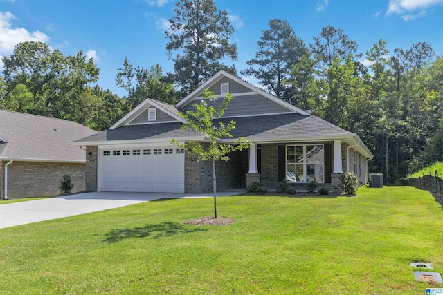 craftsman inspired home featuring a garage, a shingled roof, concrete driveway, central air condition unit, and a front yard