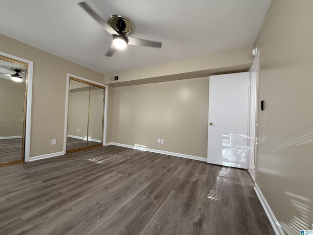 unfurnished bedroom featuring dark wood-style floors, ceiling fan, visible vents, and baseboards