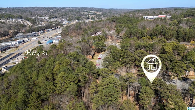 drone / aerial view featuring a forest view