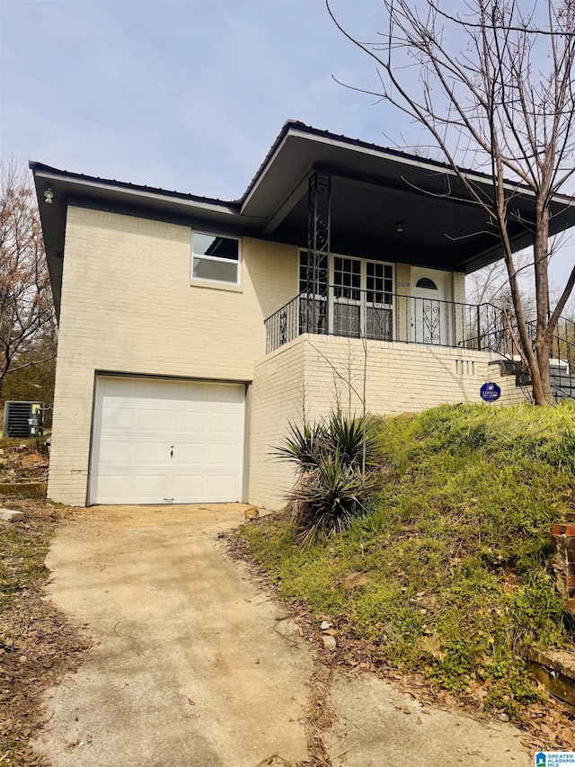 view of front facade featuring a garage, concrete driveway, brick siding, and central AC