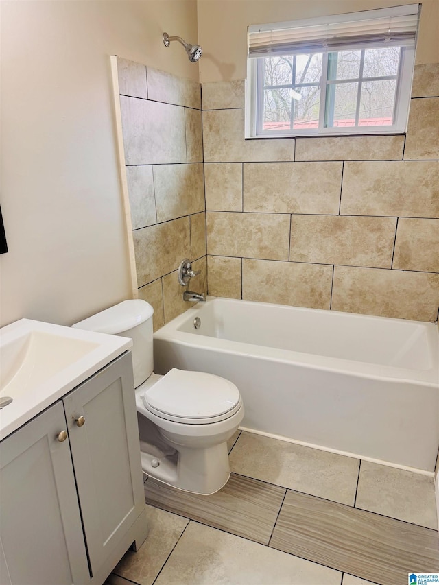 bathroom with washtub / shower combination, tile patterned flooring, a healthy amount of sunlight, and vanity