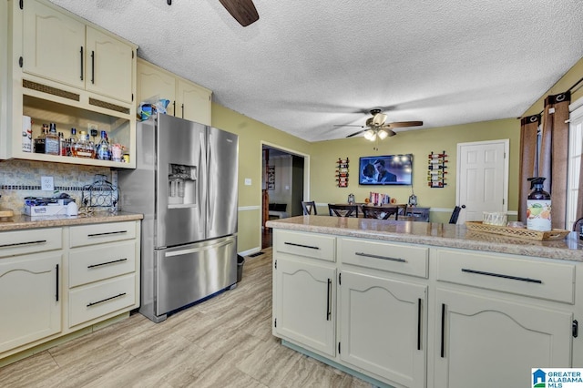 kitchen featuring open shelves, light countertops, light wood-style floors, ceiling fan, and stainless steel fridge with ice dispenser