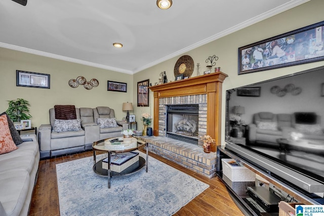 living room featuring a fireplace, crown molding, and wood finished floors