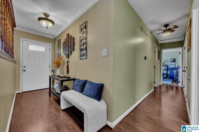 entrance foyer featuring baseboards, wood finished floors, and crown molding