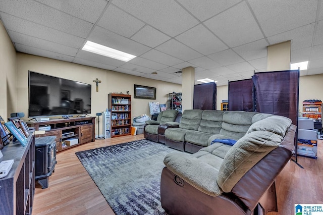 living room with a drop ceiling and light wood-style floors