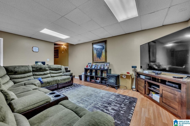 living room with a paneled ceiling and light wood-style flooring