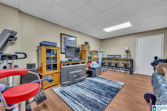 rec room with a drop ceiling and wood finished floors