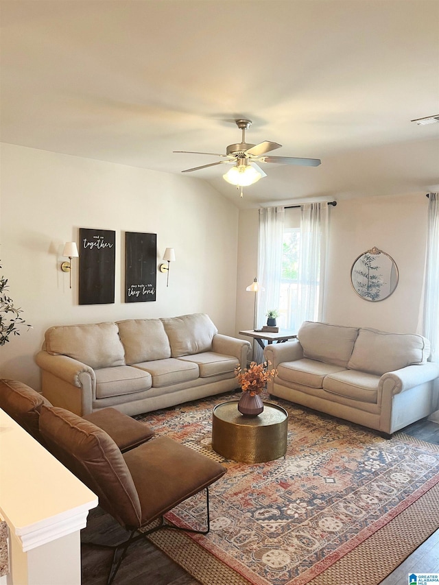 living area featuring visible vents, lofted ceiling, and ceiling fan