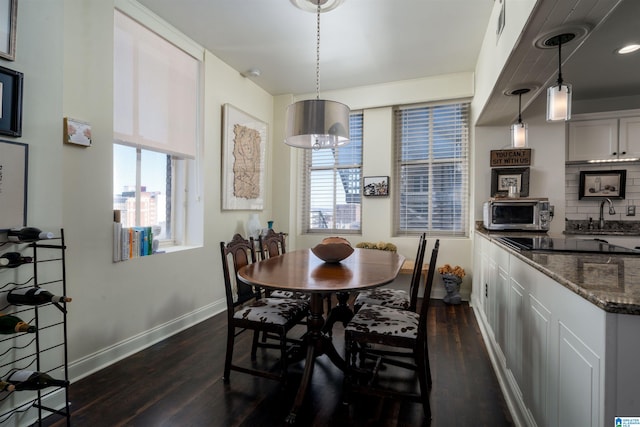 dining space featuring visible vents, baseboards, a chandelier, and dark wood-type flooring