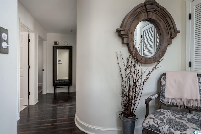 hallway with dark wood-style floors and baseboards