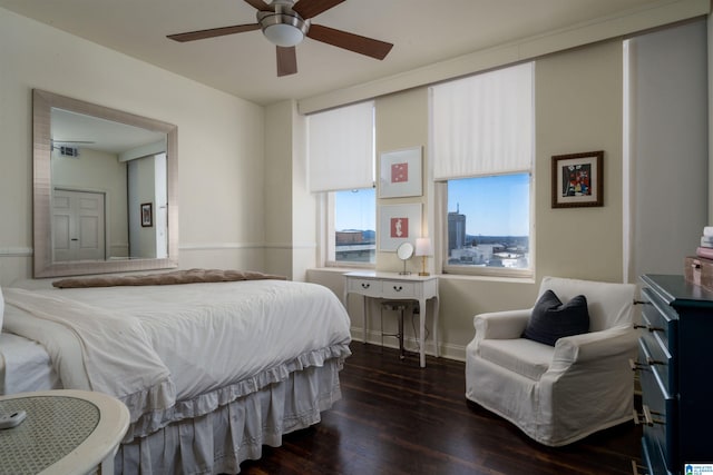 bedroom featuring a ceiling fan, dark wood-style flooring, and visible vents