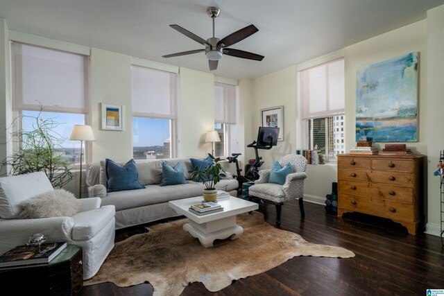 living area featuring dark wood-type flooring and a ceiling fan