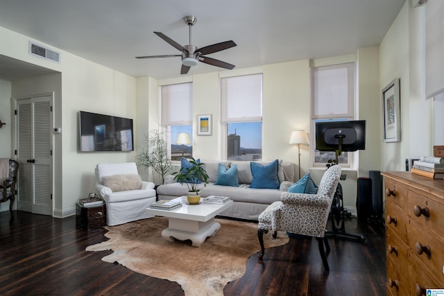 living area featuring ceiling fan, baseboards, visible vents, and dark wood finished floors