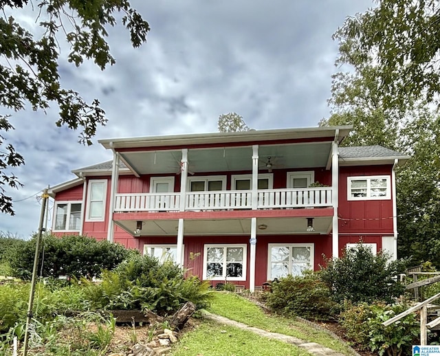 view of front of home with a balcony and ceiling fan