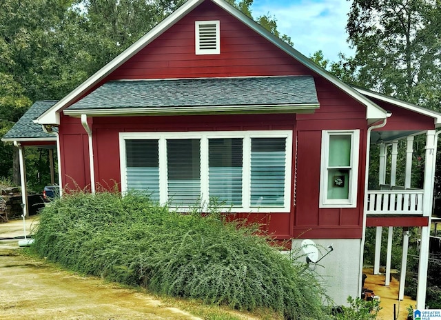 view of property exterior with roof with shingles