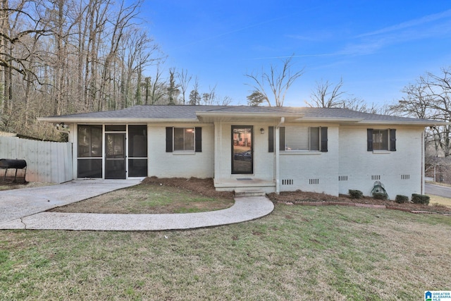 ranch-style house featuring a sunroom, a front yard, crawl space, and brick siding