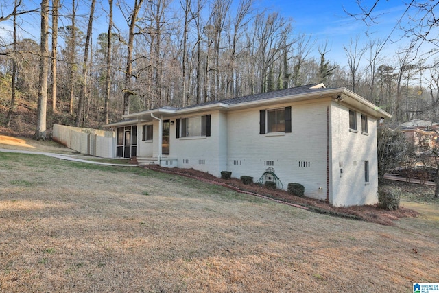 ranch-style house with brick siding, crawl space, and a front lawn