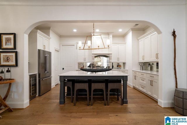 kitchen with light countertops, high end refrigerator, and white cabinetry