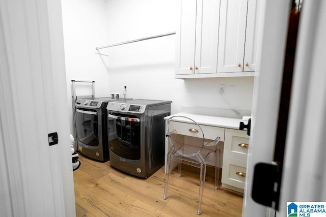 clothes washing area with light wood-style floors, cabinet space, and independent washer and dryer