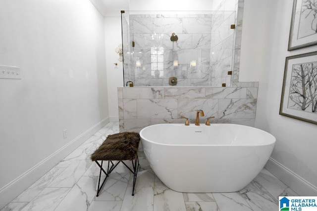 bathroom with marble finish floor, a stall shower, a soaking tub, and baseboards