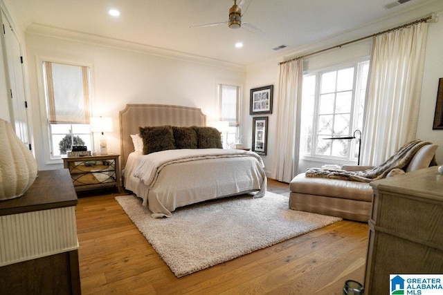 bedroom with visible vents, ceiling fan, ornamental molding, light wood-style floors, and recessed lighting