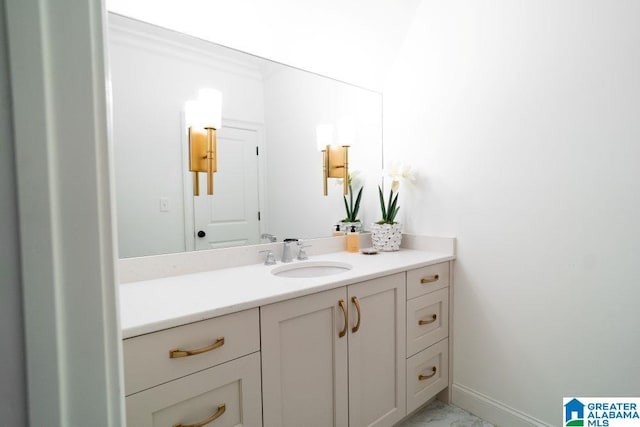 bathroom with marble finish floor, vanity, and baseboards