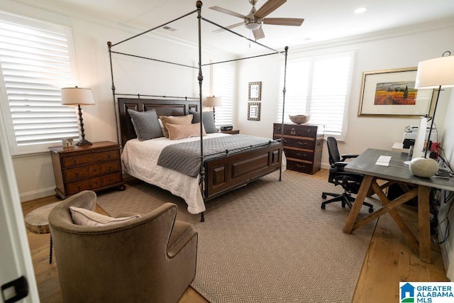 bedroom with light wood finished floors, baseboards, crown molding, and recessed lighting