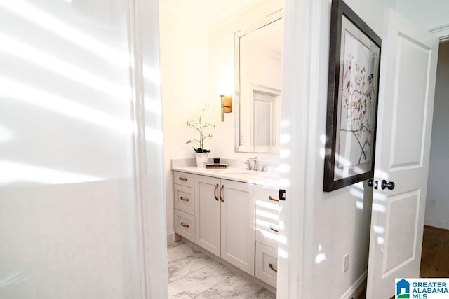 bathroom featuring marble finish floor, baseboards, and vanity