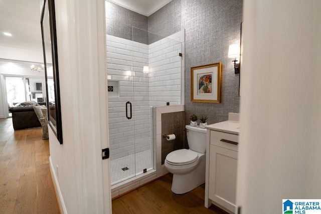 full bathroom with toilet, a stall shower, vanity, ensuite bath, and wood finished floors