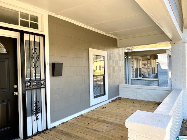 doorway to property with brick siding