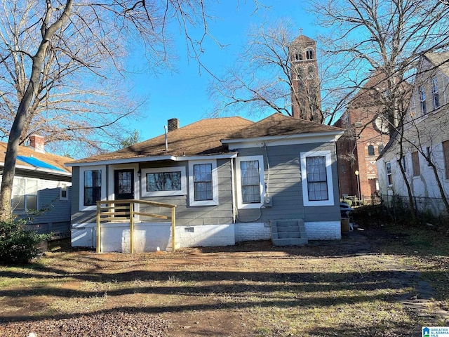 back of property featuring crawl space and a chimney