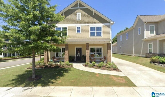 craftsman-style house with covered porch and a front lawn