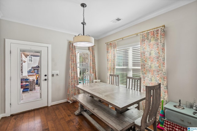 dining space with baseboards, visible vents, dark wood finished floors, and ornamental molding