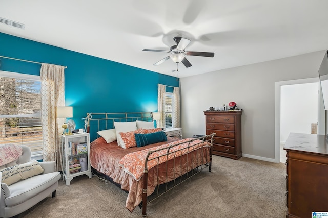 bedroom featuring a ceiling fan, carpet, visible vents, and baseboards