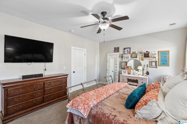 bedroom featuring light carpet, visible vents, and a ceiling fan