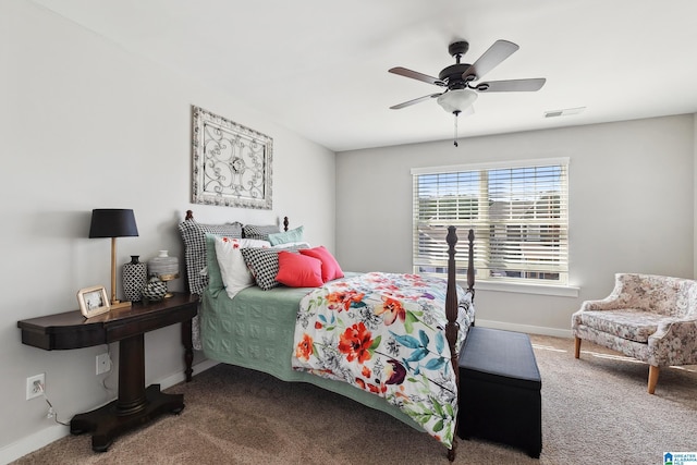 carpeted bedroom featuring a ceiling fan, visible vents, and baseboards