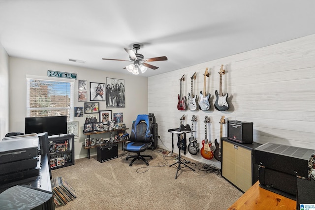 office area featuring a ceiling fan, visible vents, and carpet flooring