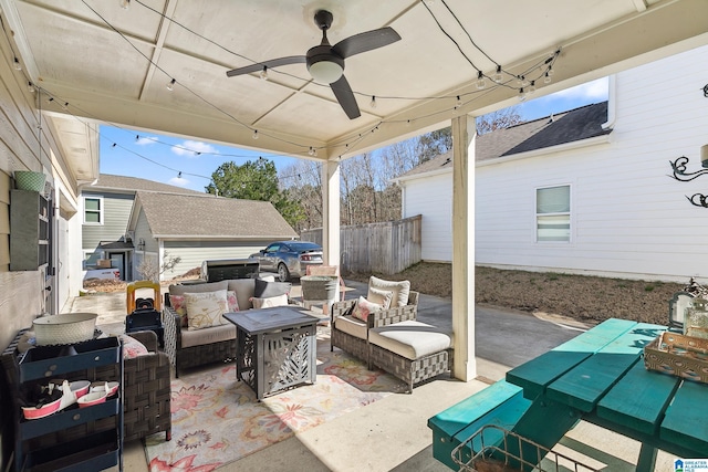 view of patio featuring ceiling fan, fence, and an outdoor living space