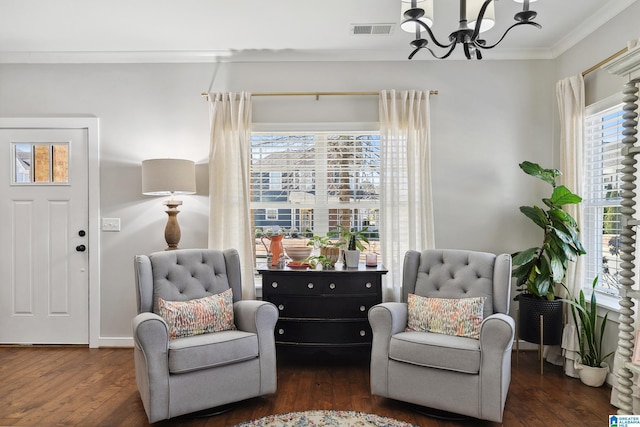 sitting room featuring dark wood-style floors, ornamental molding, visible vents, and a healthy amount of sunlight