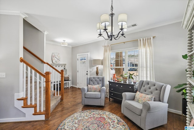 living area with stairs, an inviting chandelier, dark wood finished floors, and crown molding