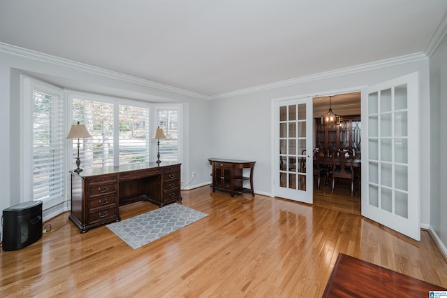 office featuring ornamental molding, light wood-type flooring, french doors, and baseboards