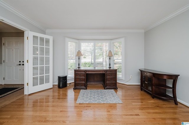 home office featuring baseboards, light wood finished floors, and crown molding