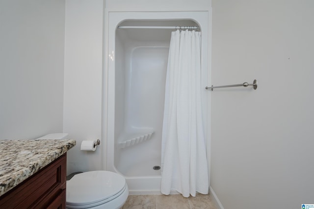 full bathroom featuring a stall shower, tile patterned flooring, vanity, and toilet