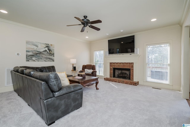 living room featuring ornamental molding, carpet, visible vents, and a brick fireplace