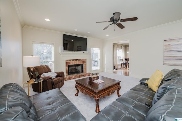 living area featuring baseboards, crown molding, carpet flooring, a brick fireplace, and recessed lighting