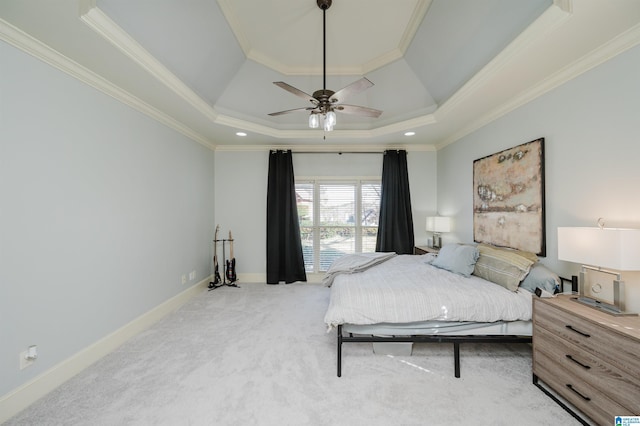 bedroom featuring carpet flooring, a ceiling fan, baseboards, a tray ceiling, and crown molding